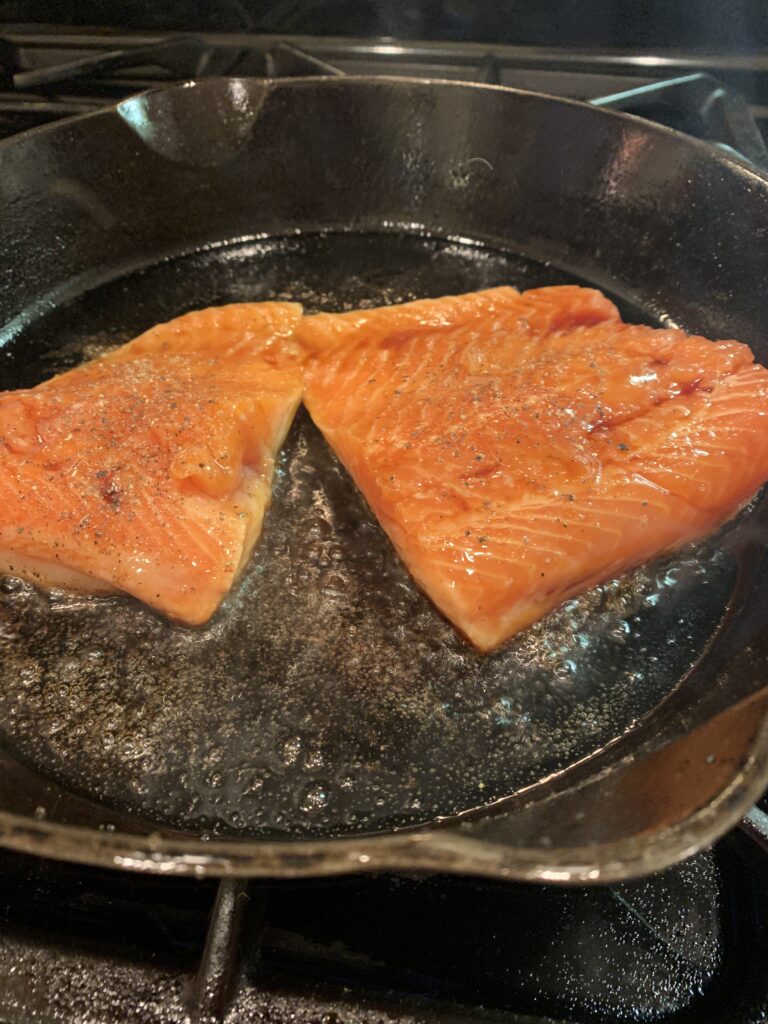 Salmon, skin side down in the skillet. 