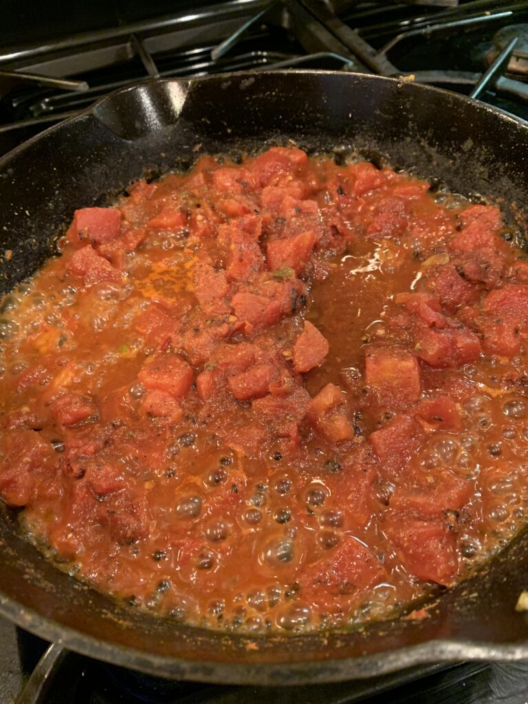 Tomato sauce simmering in a skillet. 