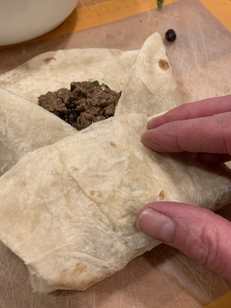 Burrito filing covered by flour tortilla.