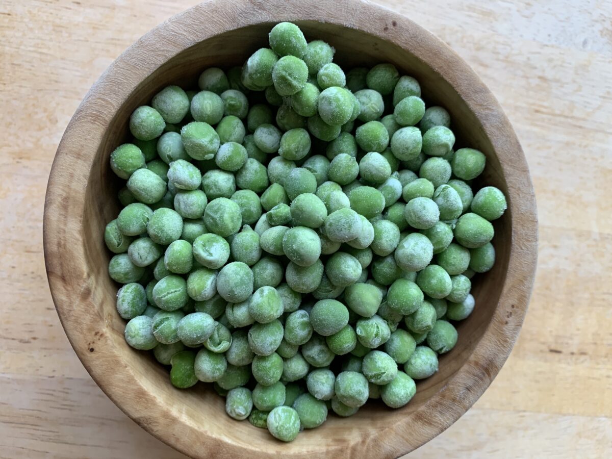 Frozen peas in a small bowl.