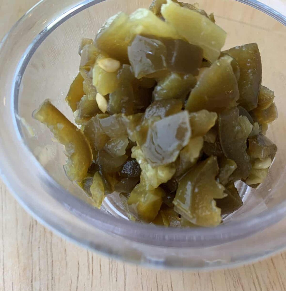 Diced jalapeno peppers in a small bowl.