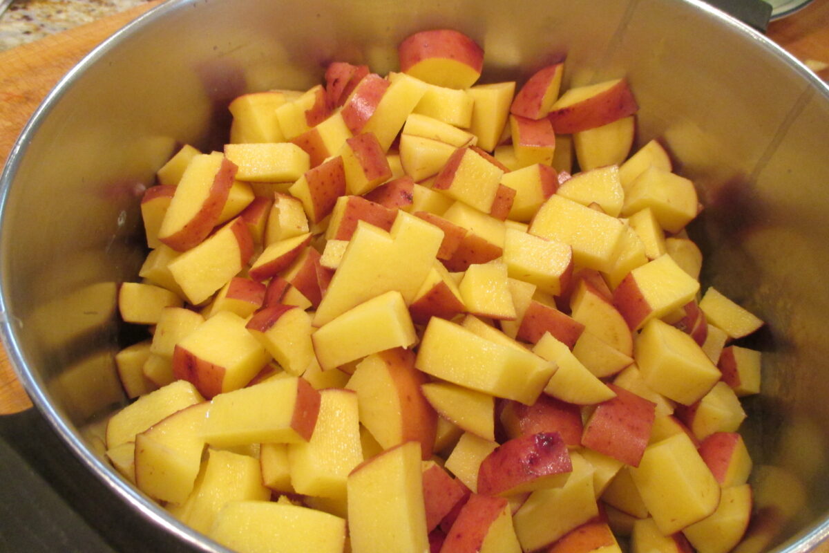 Diced red potatoes in a pan.