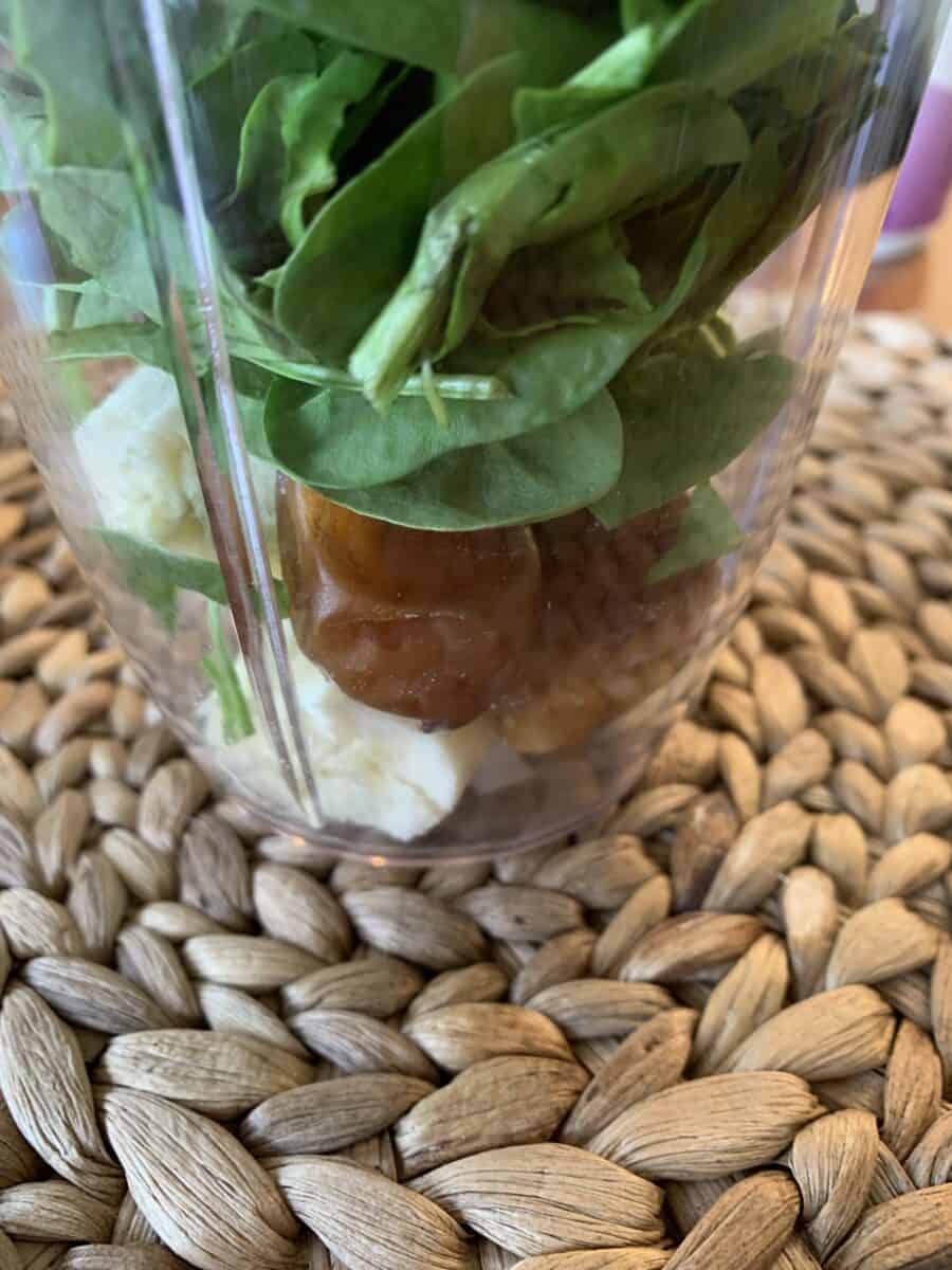 Spinach, dates and banana in a blender cup.