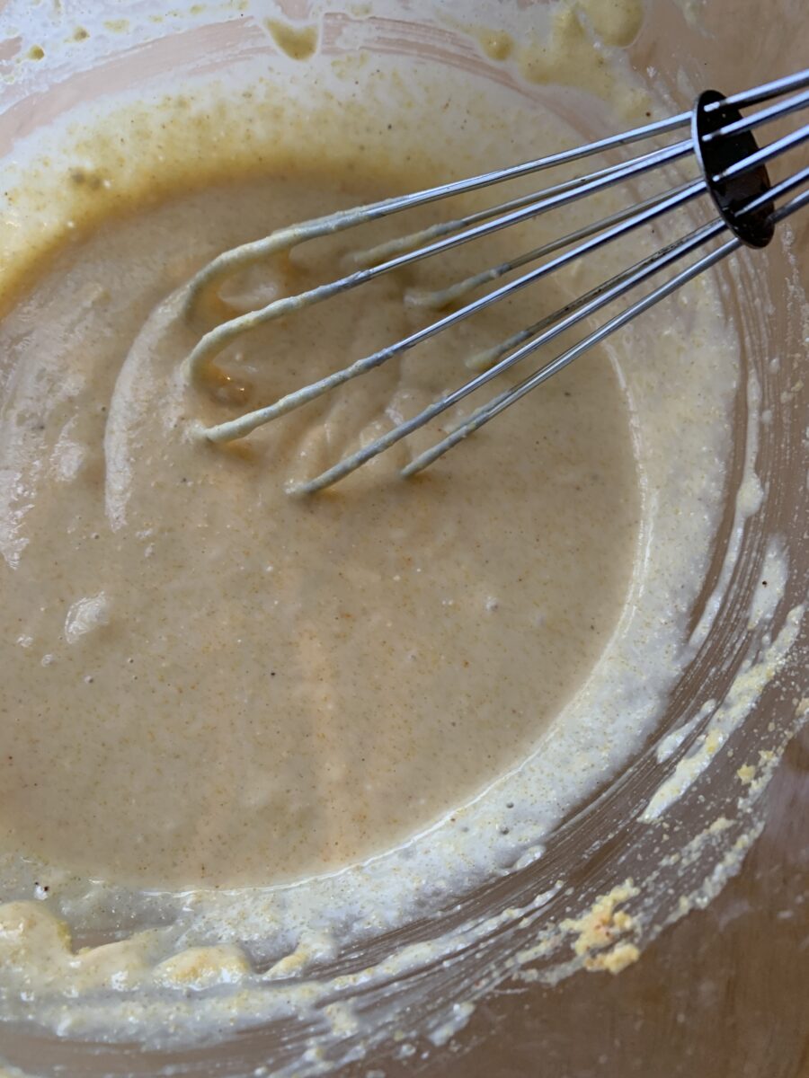 Raw batter in a bowl with a wisk.