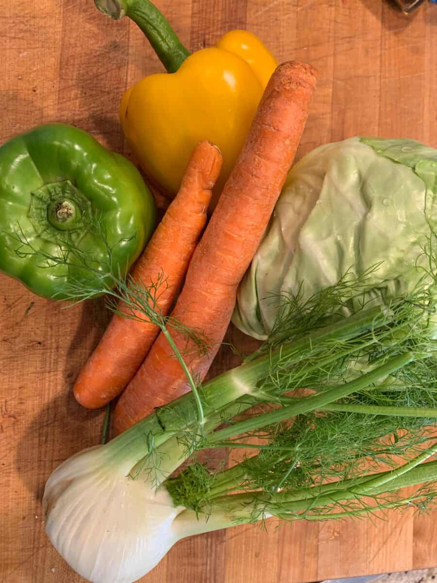 Cole slaw ingredients on a cutting board. 