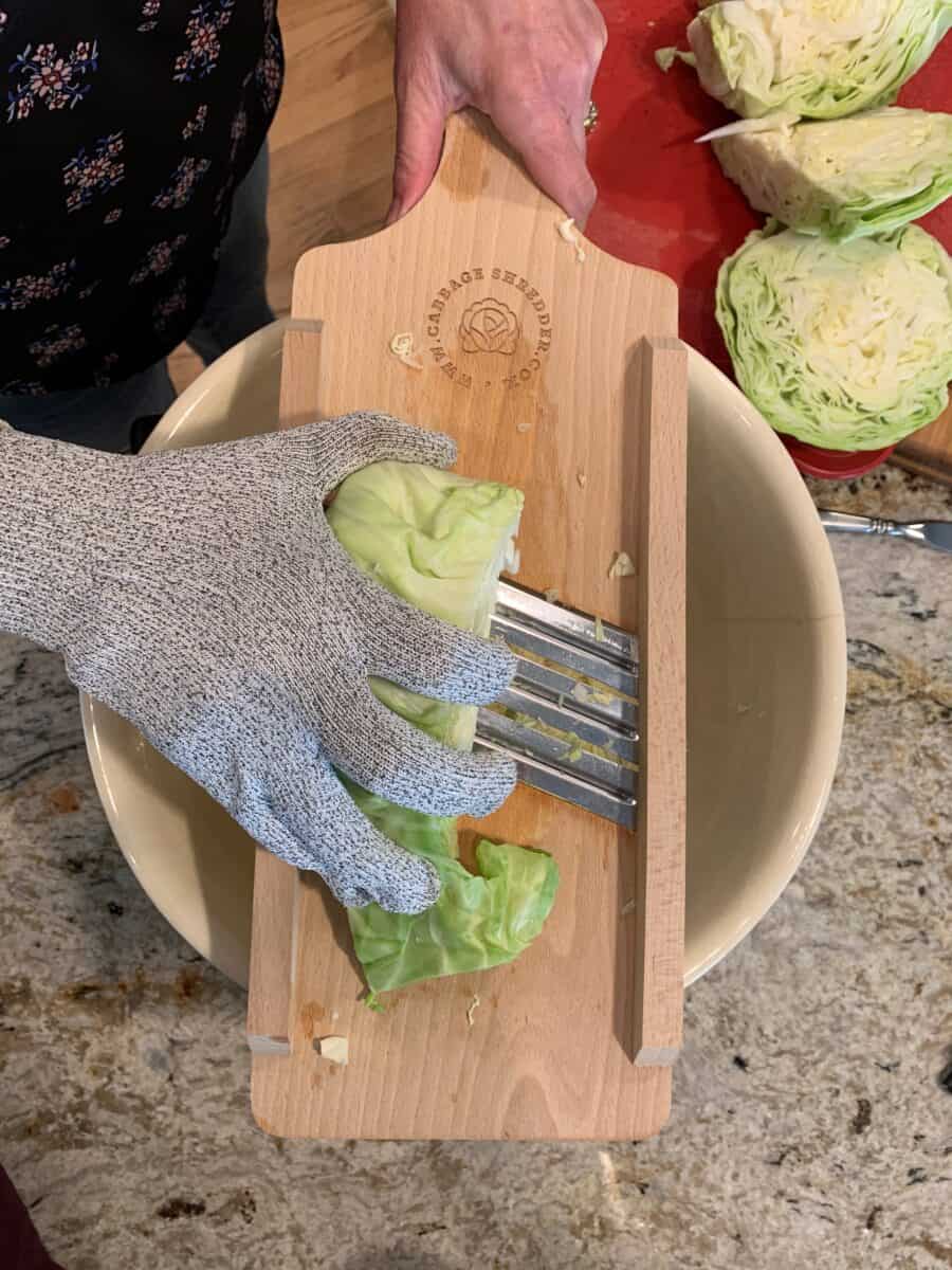 A protective glove worn, shows how to safely use a mandolin shredder. 