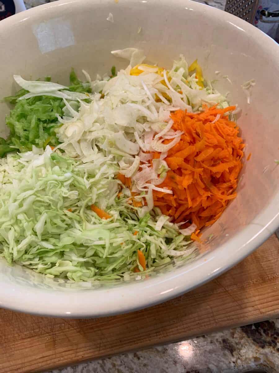 Cole slaw ingredients, shredded in a bowl.