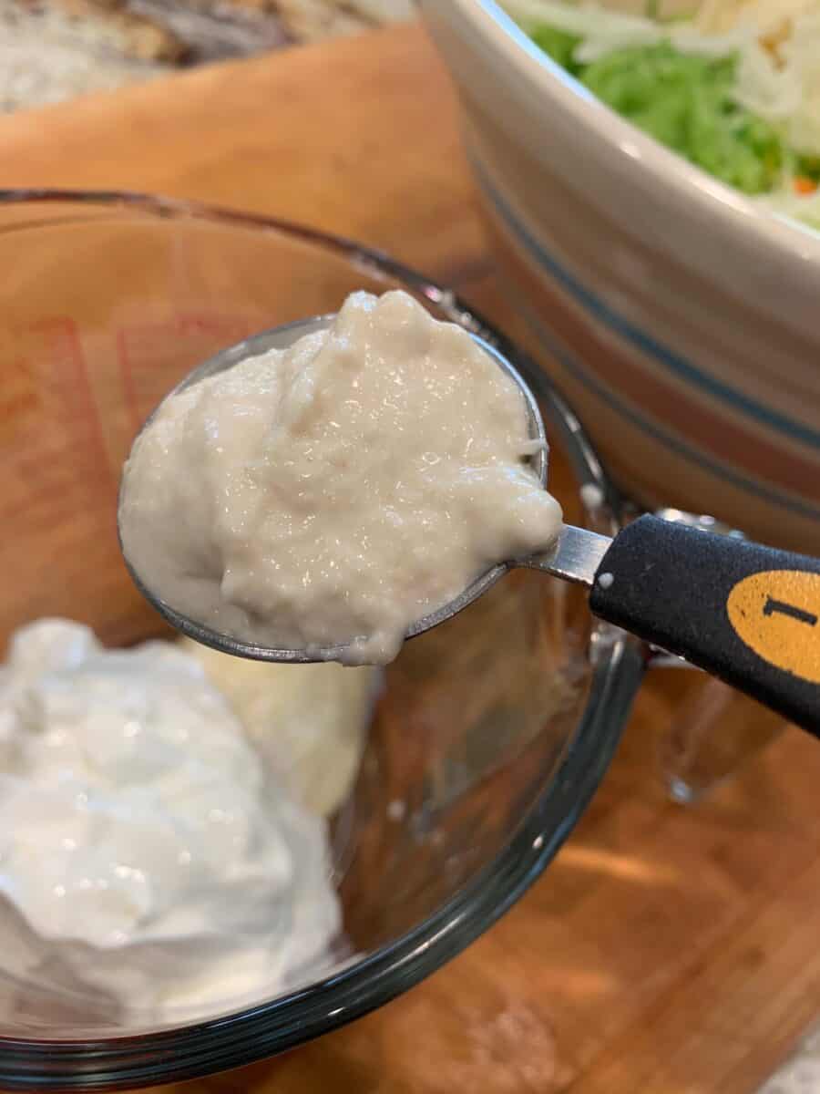 Horseradish in spoon plus cole slaw dressing ingredients. 