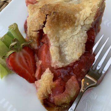A slice of strawberry rhubarb pie on a plate
