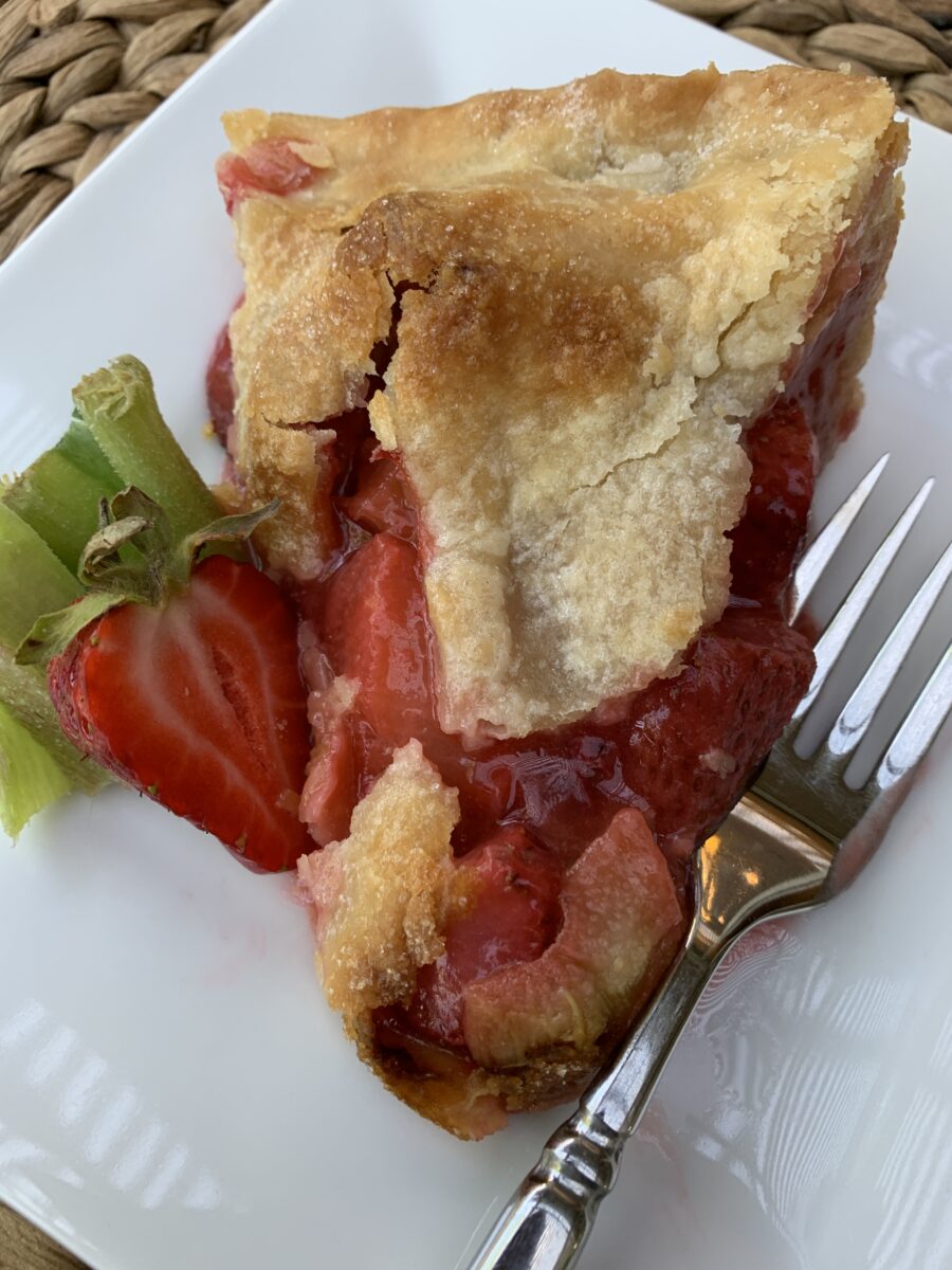 A slice of strawberry rhubarb pie on a plate