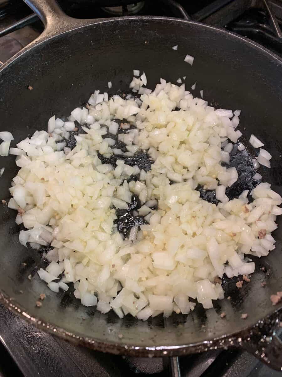 diced onions in a cast iron skillet