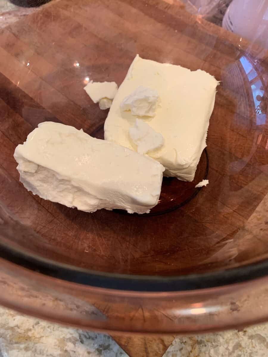 Goat cheese and cream cheese in a glass bowl.