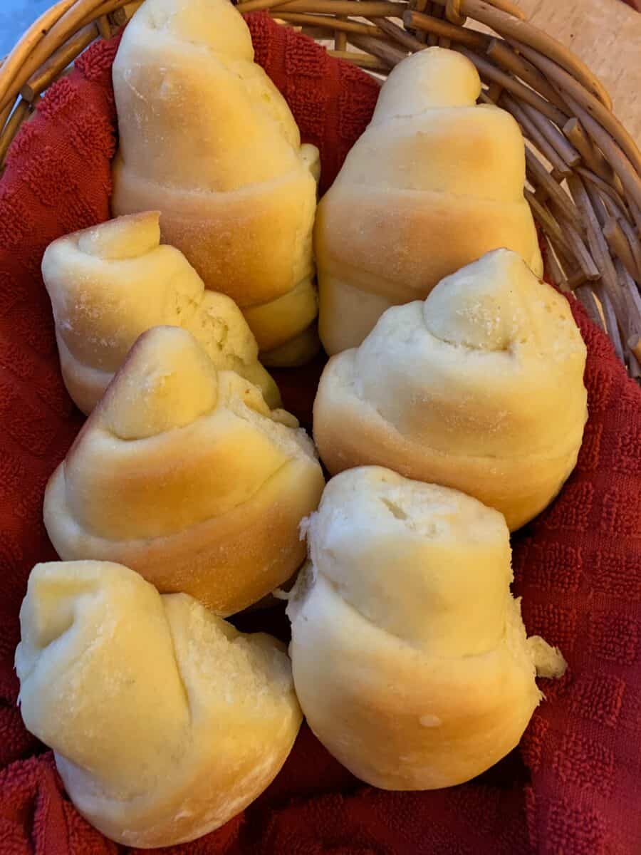 A basket full of freshly baked potato rolls.