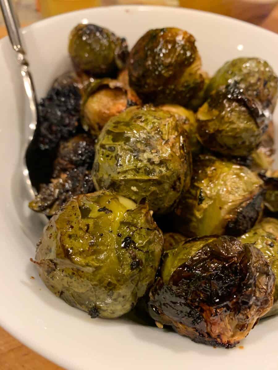 Brussel sprouts on a serving plate with a fork