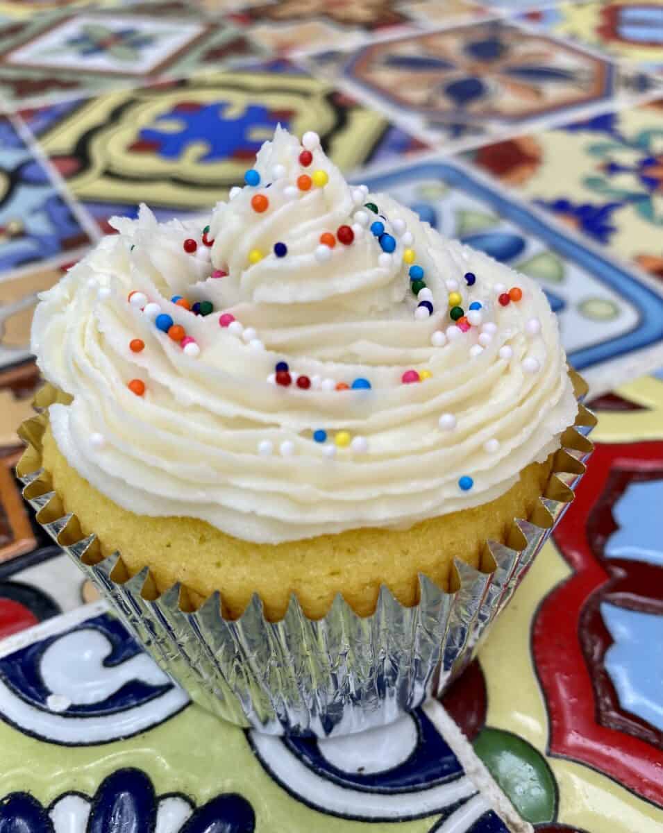 Frosted cupcake on a table.