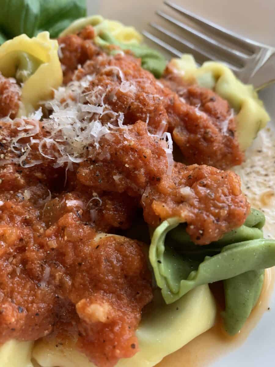 Tomato-cream sauce on top of plain and spinach tortellini.