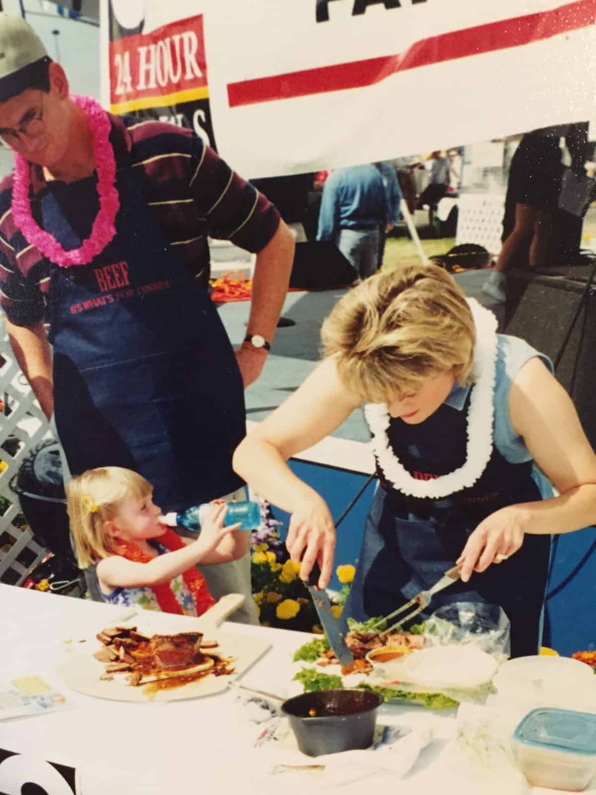 Melinda checking the meat, with her family standing by.