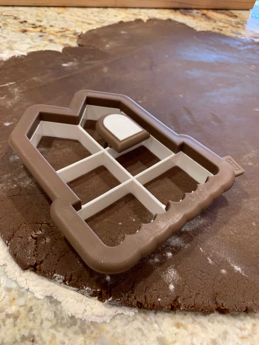 Cookie cutter placed on a rolled sheet of gingerbread dough. 