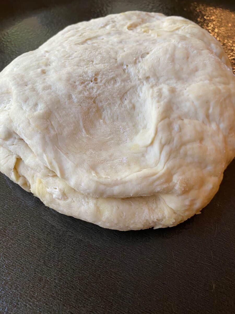 Pizza dough on a cutting board. 