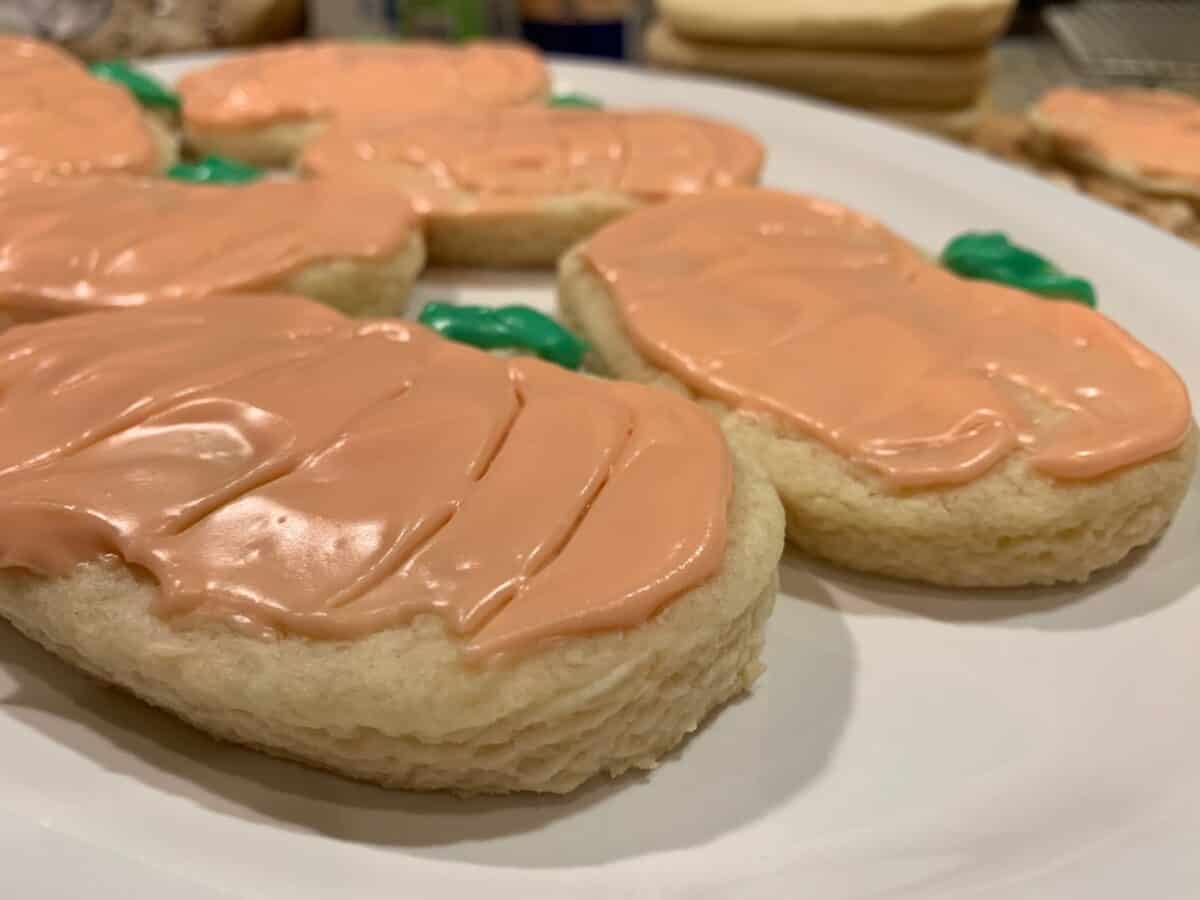 Frosted sugar cookies on a plate.