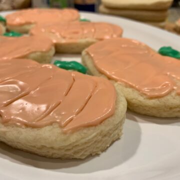 Frosted sugar cookies on a plate.