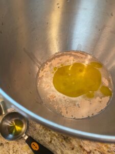 Yeast, water, sugar and salt in a mixing bowl.