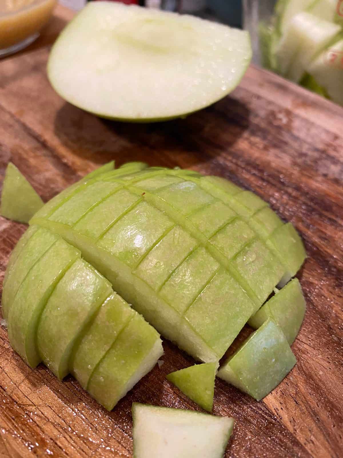 One half of an apple, skin side up and diced into small portions.