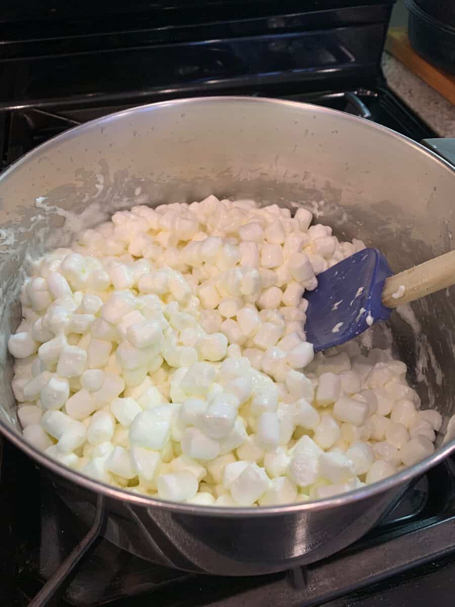 Mini-marshmallows and butter melting in a pot on the stove.