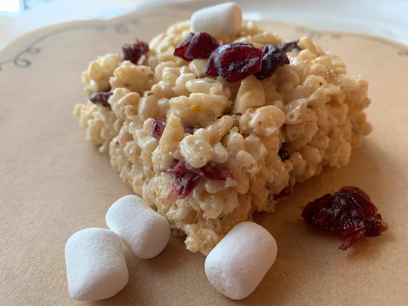 One portion of a treat with marshmallows and dried cranberries on the side and top.