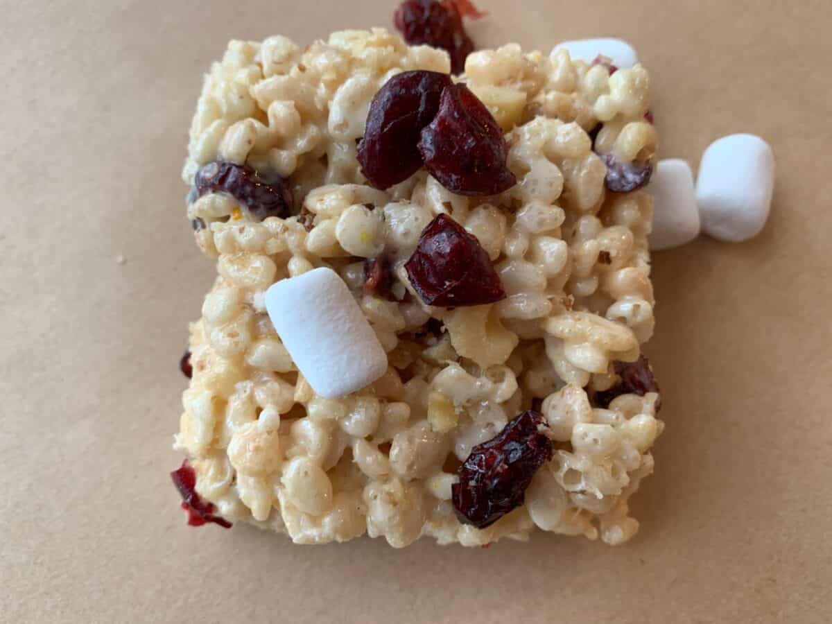 Rice Krispie square with mini-marshmallows and dried cranberries on top.