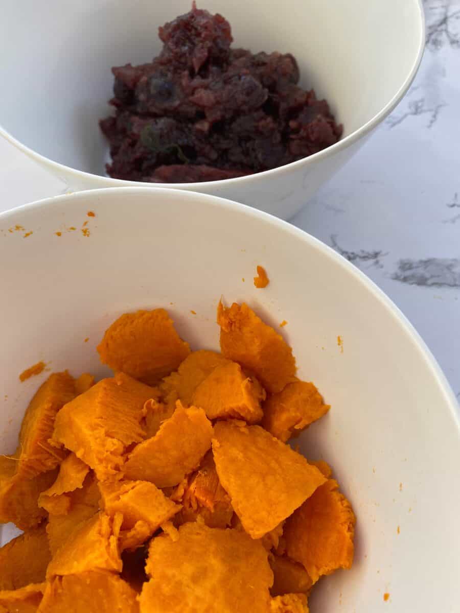 Sweet potatoes and cranberries in two small bowls.