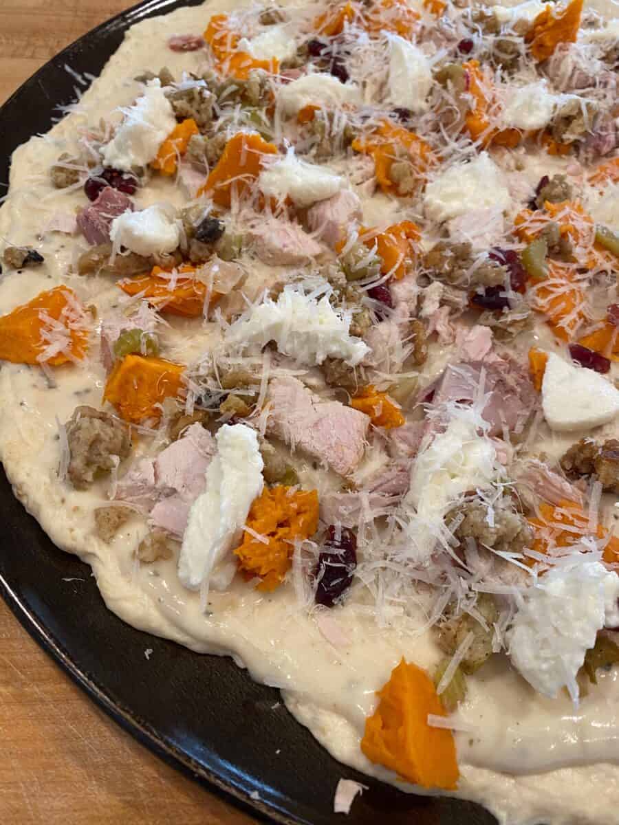 Unbaked leftover turkey pizza.