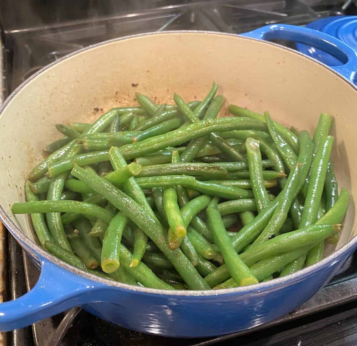 Green beans sautéing on the stove.