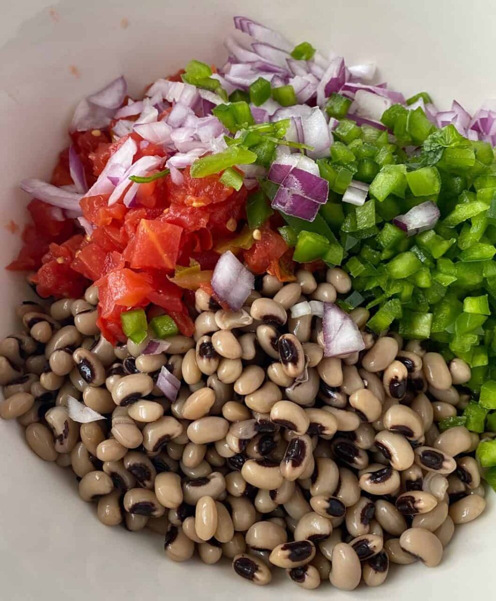 Salad ingredients in a bowl, not mixed together.