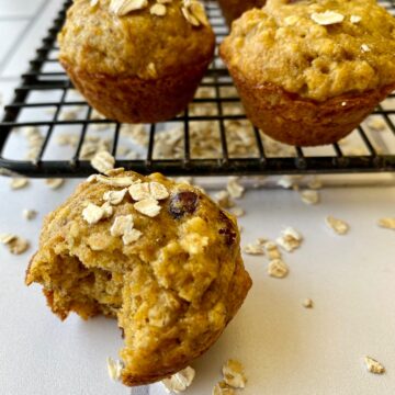 Banana carrot muffins with oats on a cooling rack.