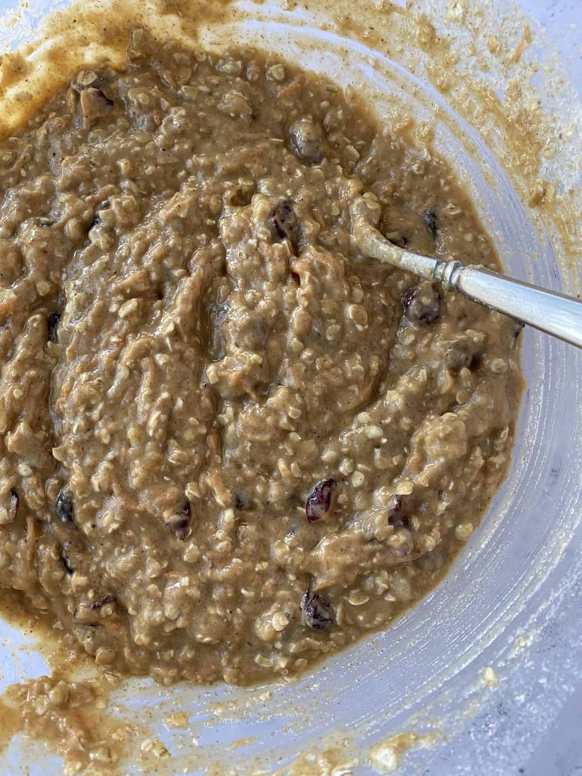 Raw dough in a bowl with a spoon.