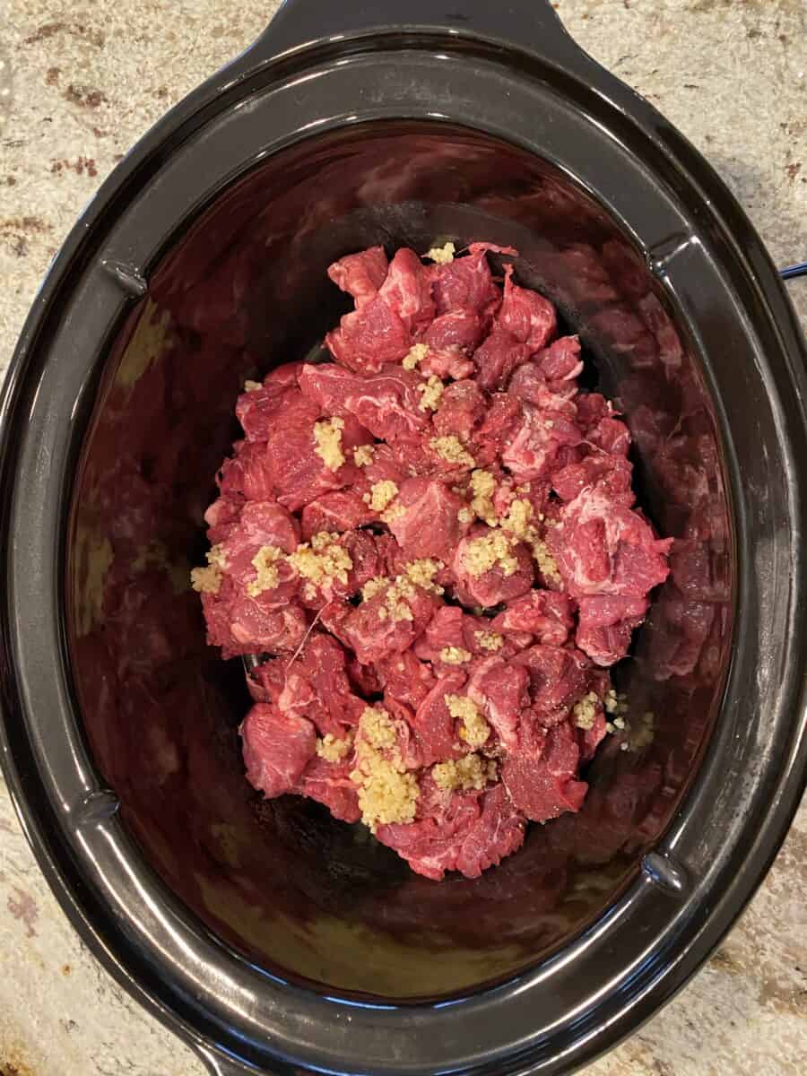 Beef and garlic in a crockpot. 