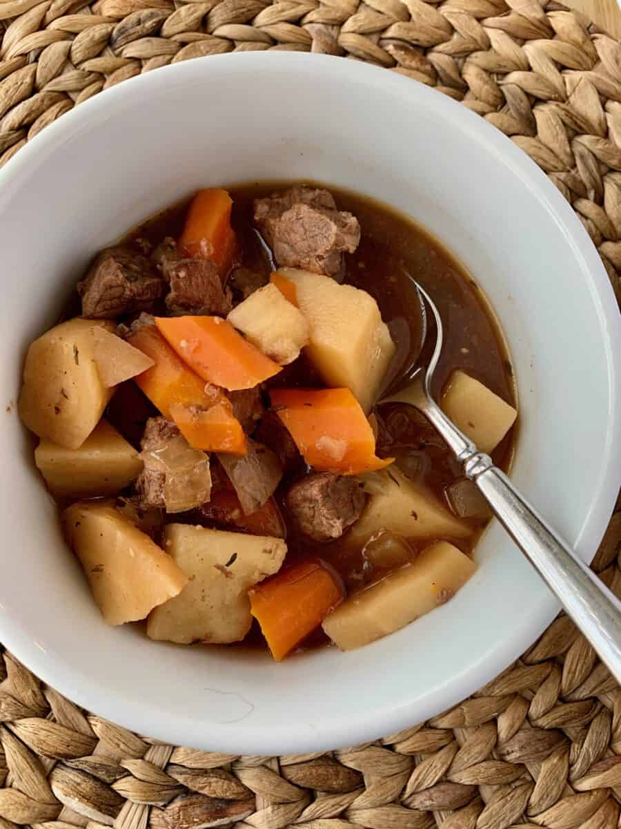 Irish stew in a small bowl with a spoon. 