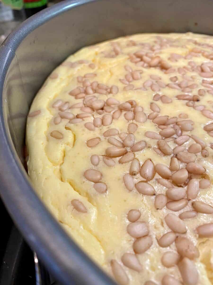 Side view of the cheesecake with small cracks around the edges.