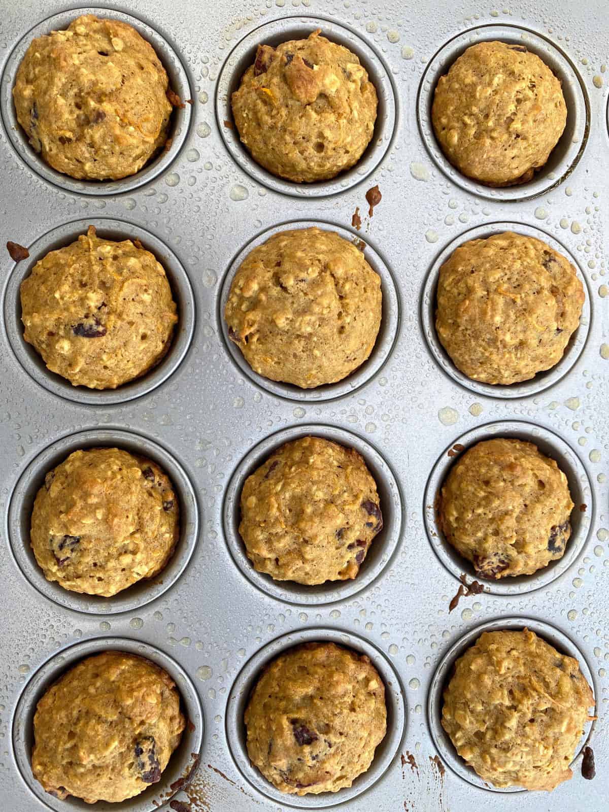 twelve cooked mini banana muffins in a tin