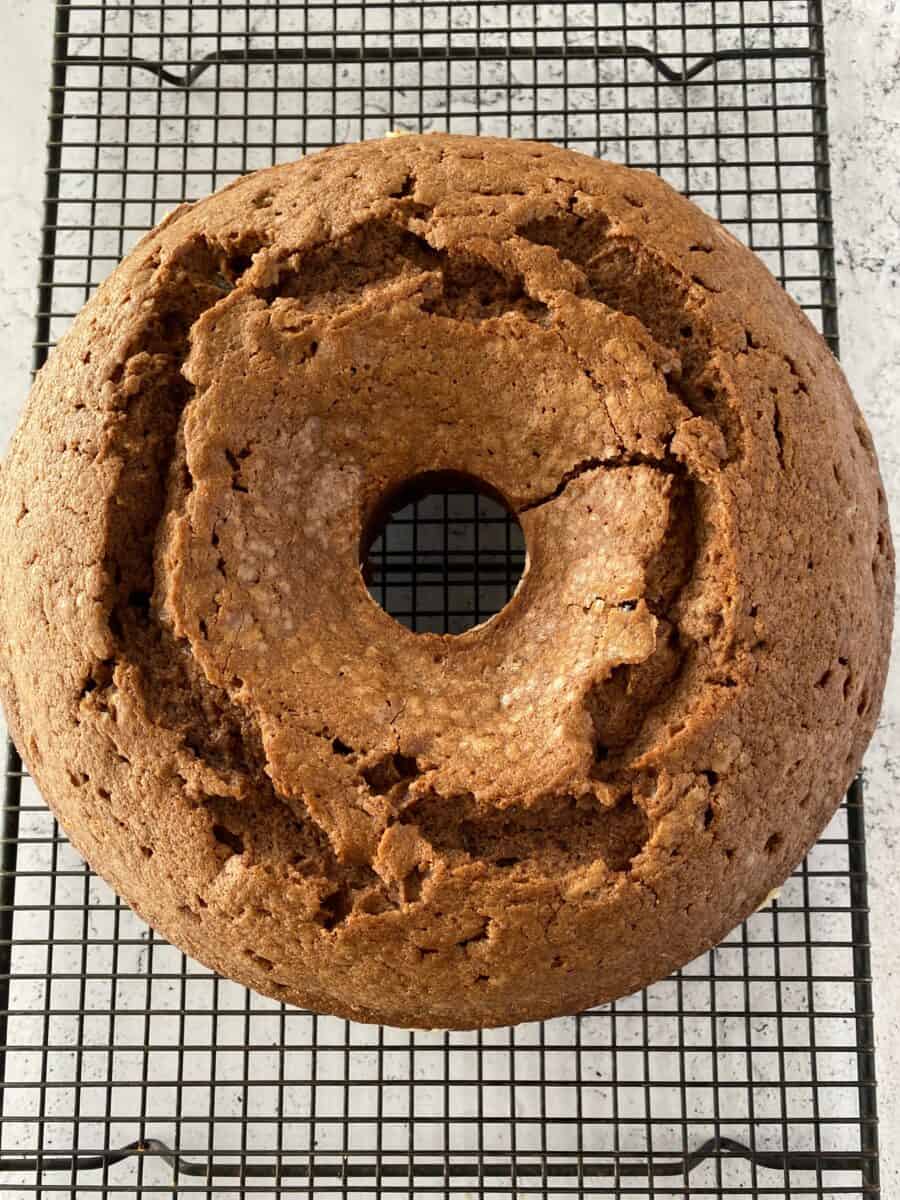 Whole pound cake on a cooling rack.