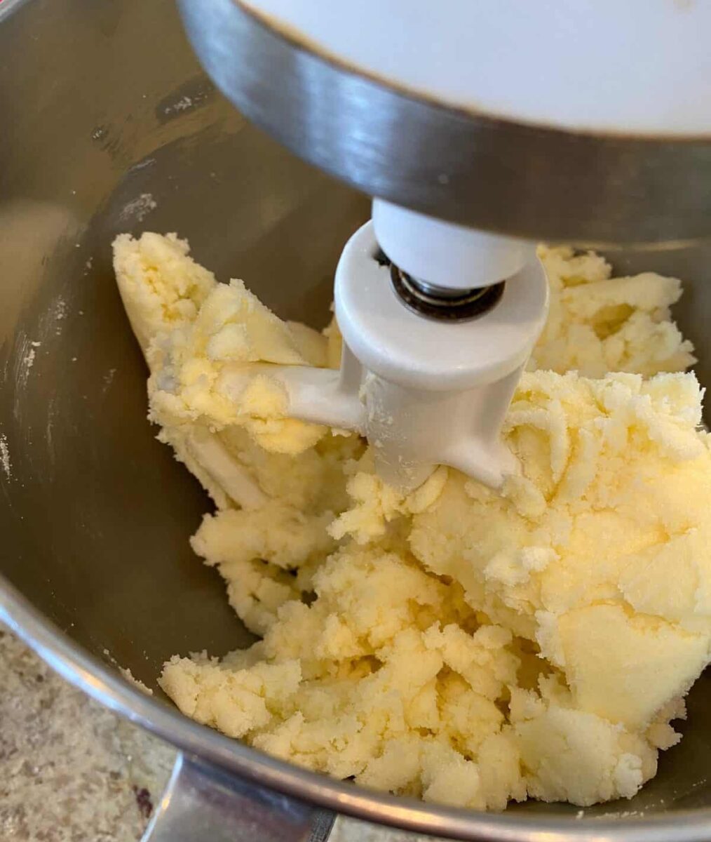 Butter and sugar combined in a mixing bowl.