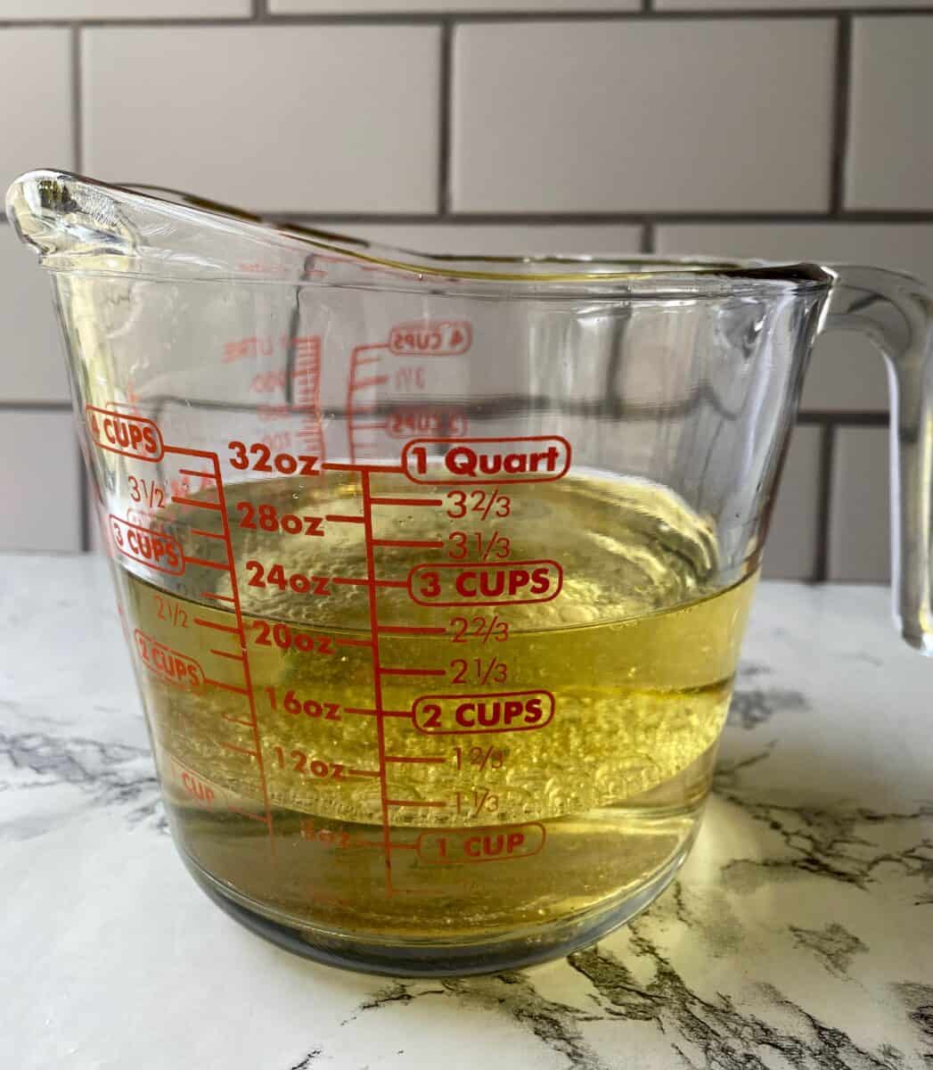 Olive oil and white wine vinegar in a 4-cup glass measuring cup.