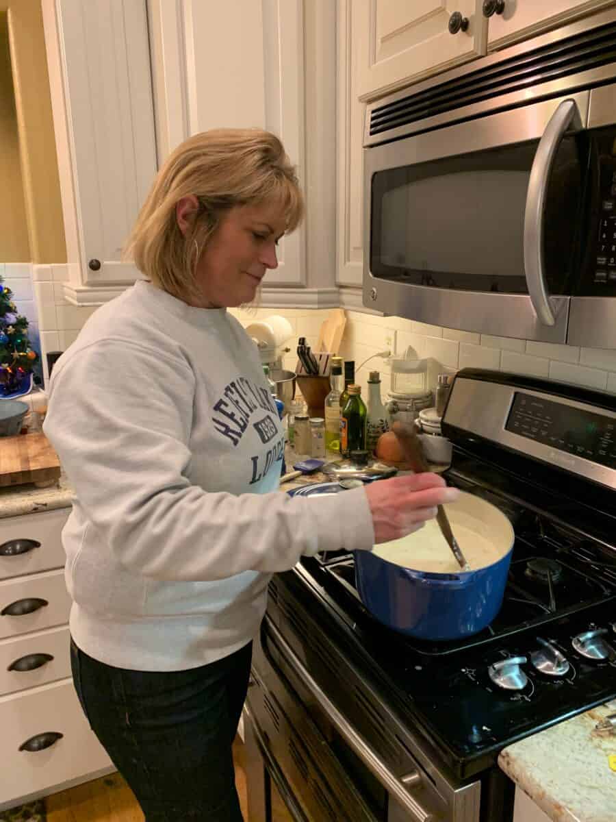 Melinda standing at the stove in the kitchen.