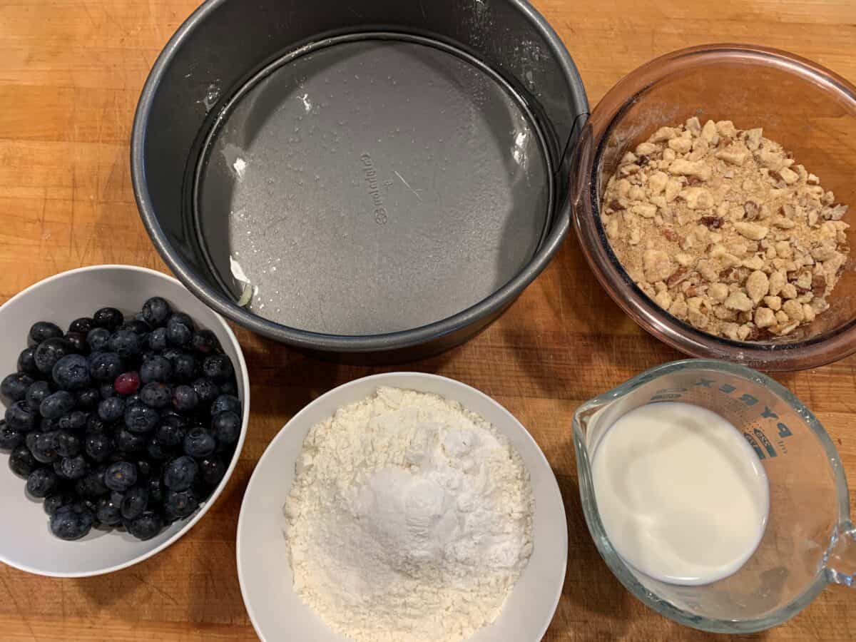 Ingredients for blueberry cake spread out on a cutting board. 