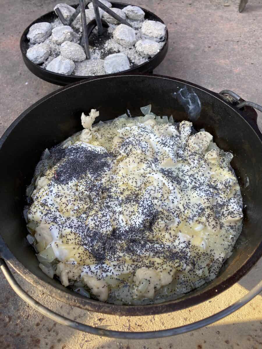 Chicken and onions cooking in a Dutch Oven