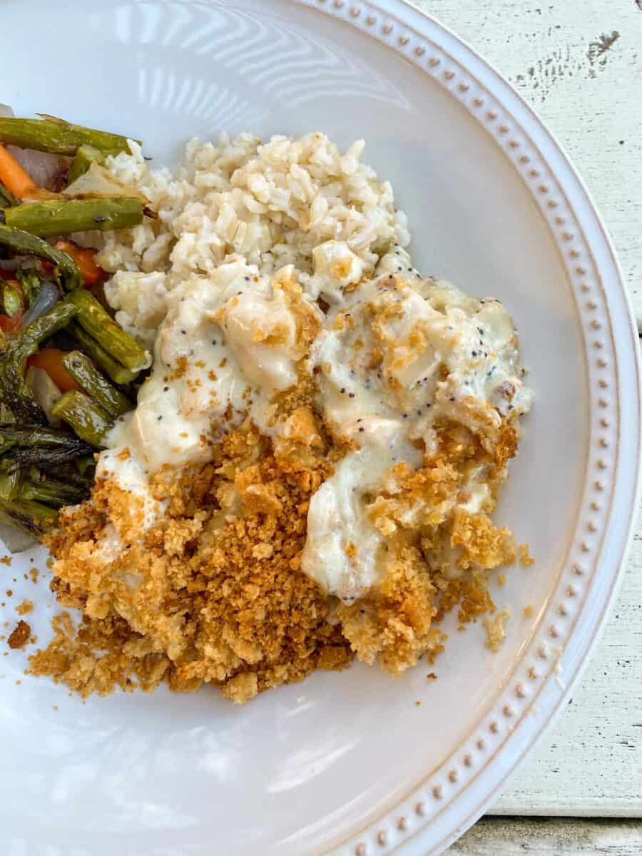 A scoop of chicken with green beans and rice on a plate. 