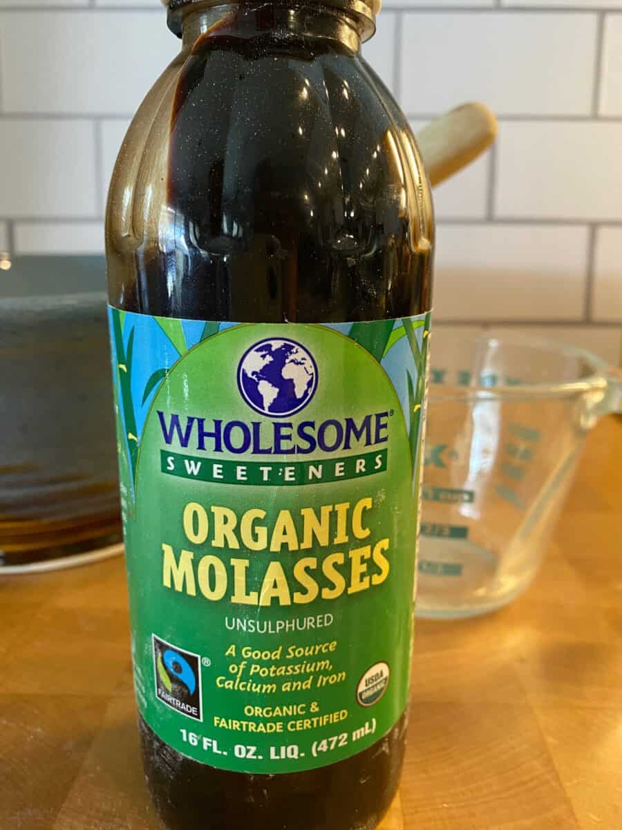 A jar of molasses on a counter.