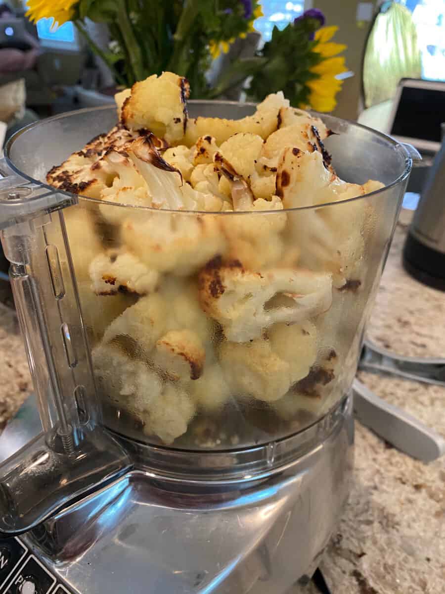 Cauliflower Hummus ingredients in the bowl of a food processor. 