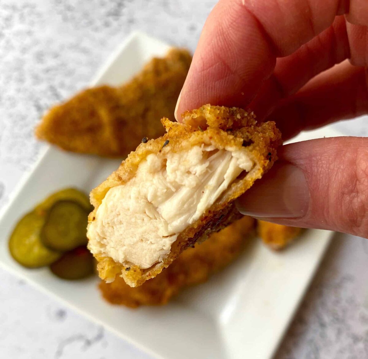 Chicken Strips Or Nuggets Being Deep-fried In A Cast-iron Frying